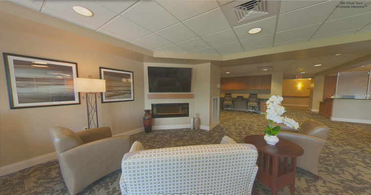 a virtual tour of a living room with chairs and a fireplace