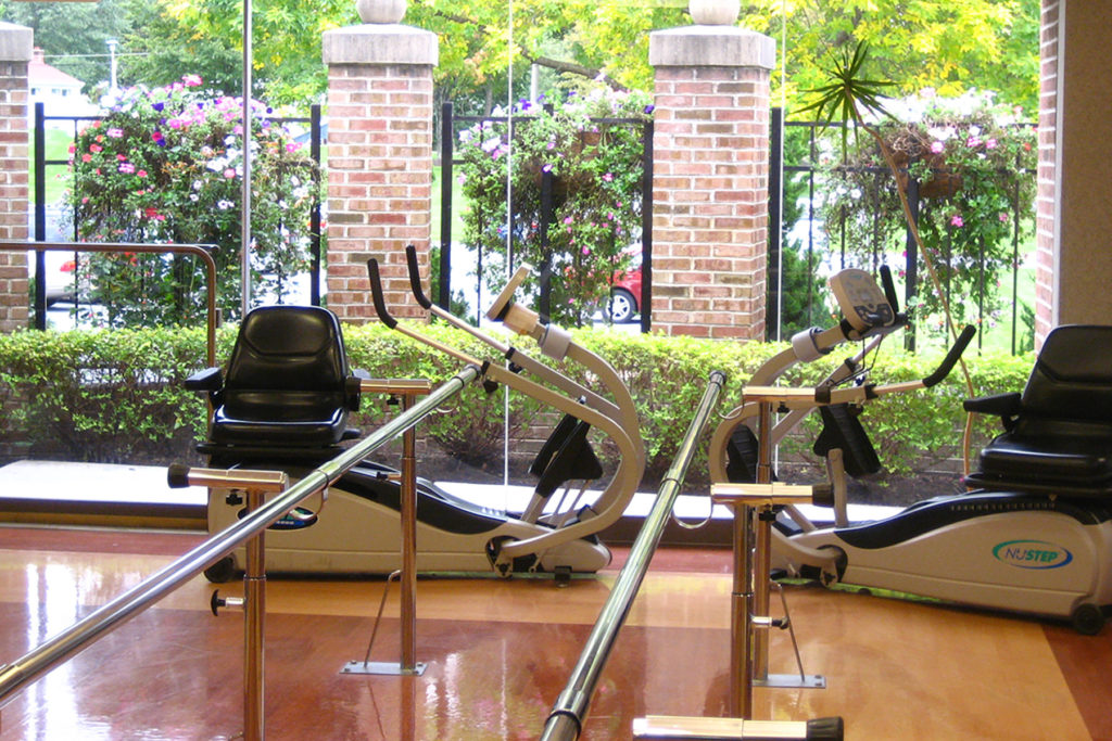 a gym with a few exercise bikes and a treadmill