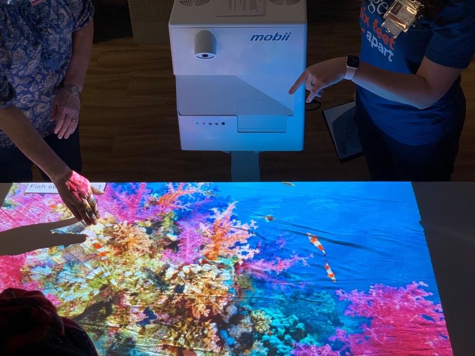 A seascape is projected onto a table
