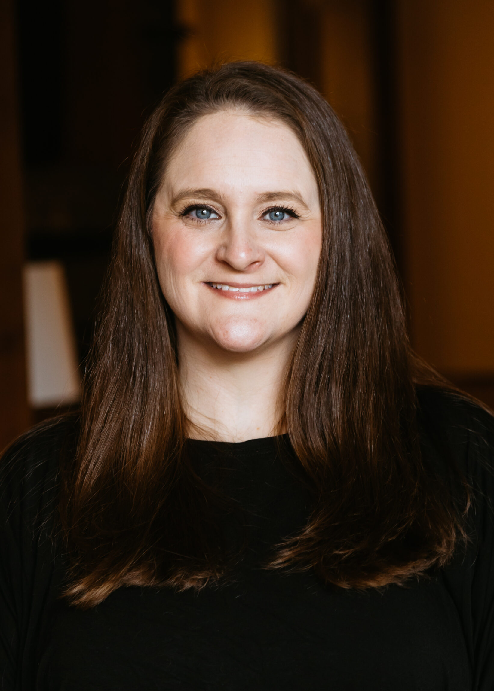 Headshot of a woman with blue eyes and brown hair