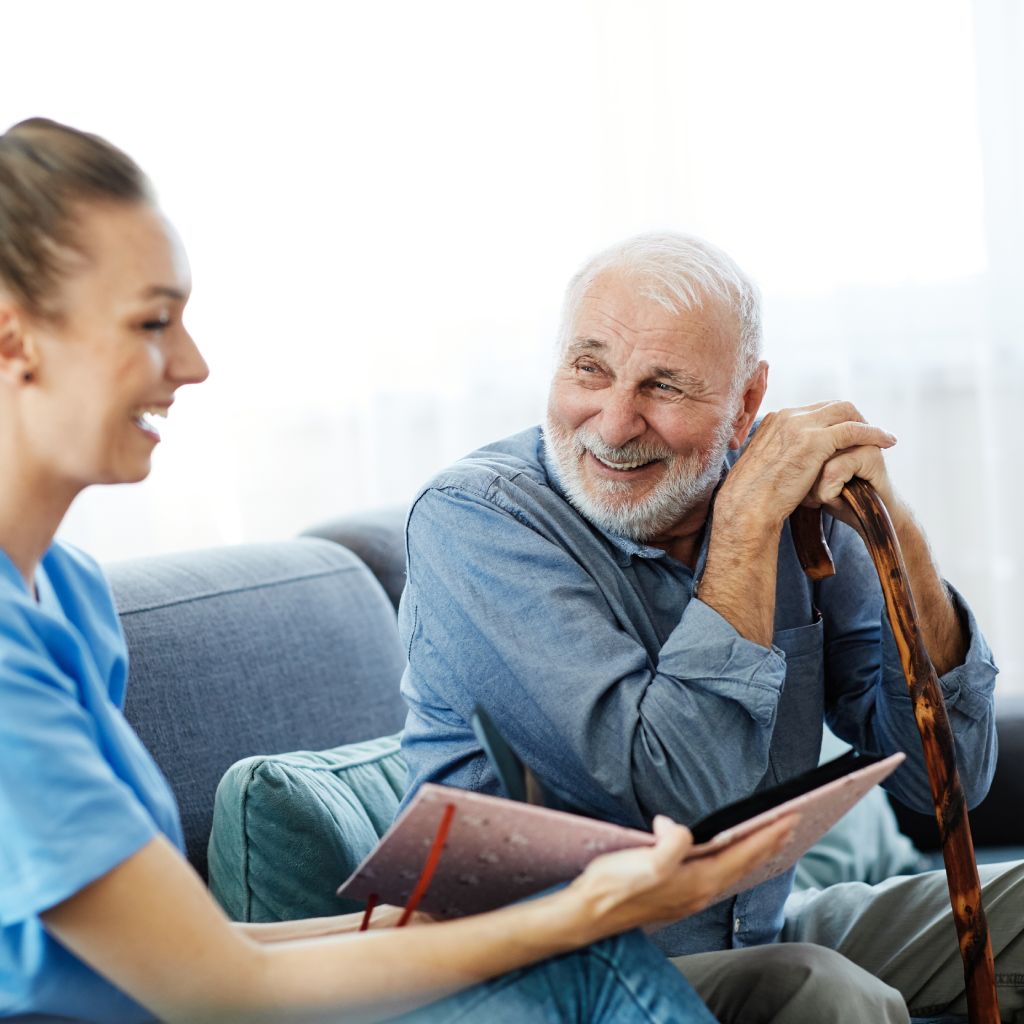 A man with a cane listens to a story being read to him