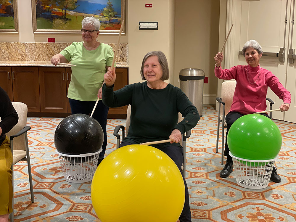 Messiah Lifeways residents drum on exercise balls