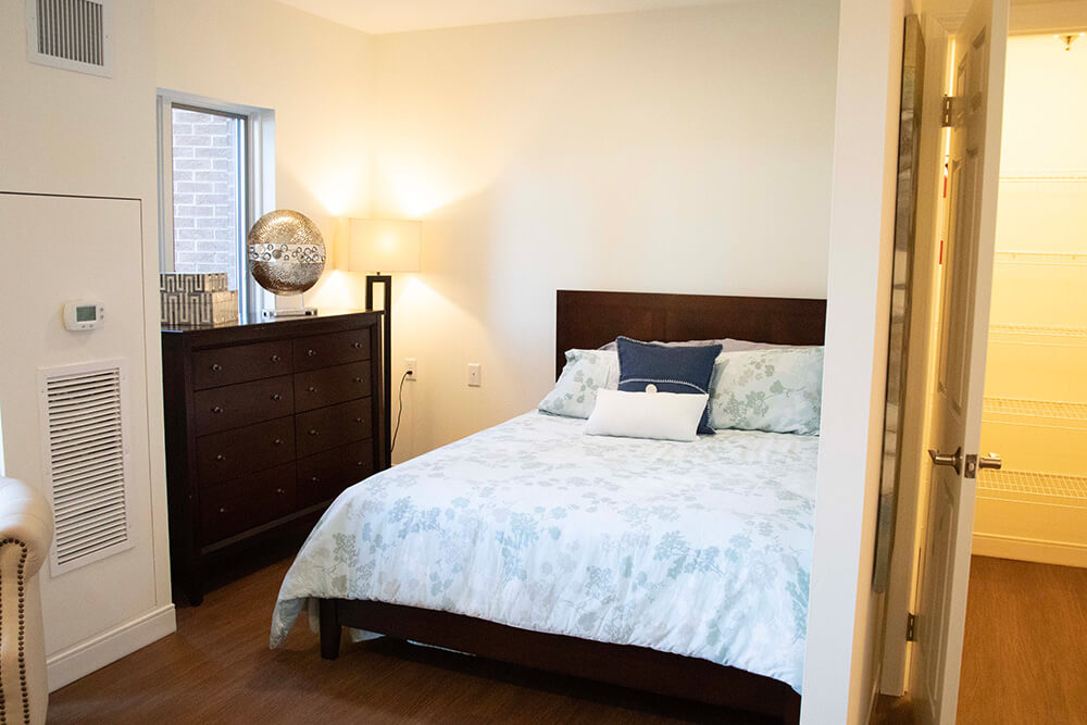 a bedroom with a large bed and a dresser
